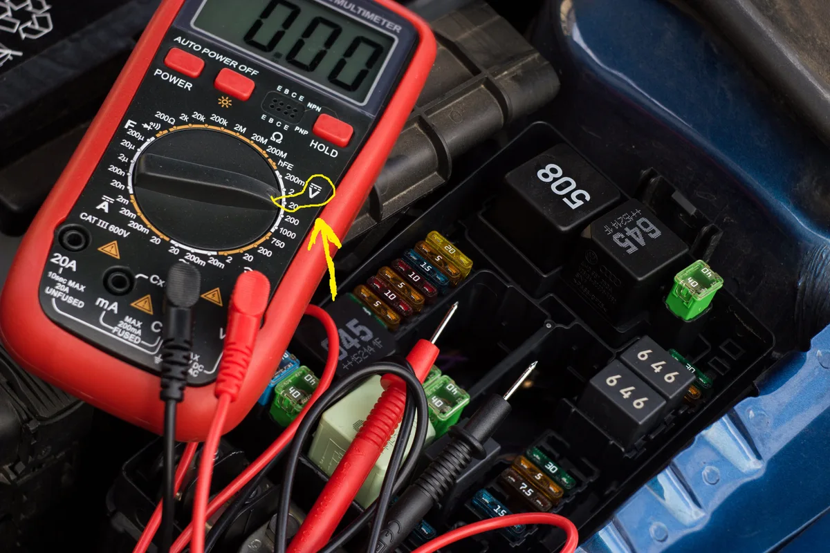testing car battery terminals with multimeter probes